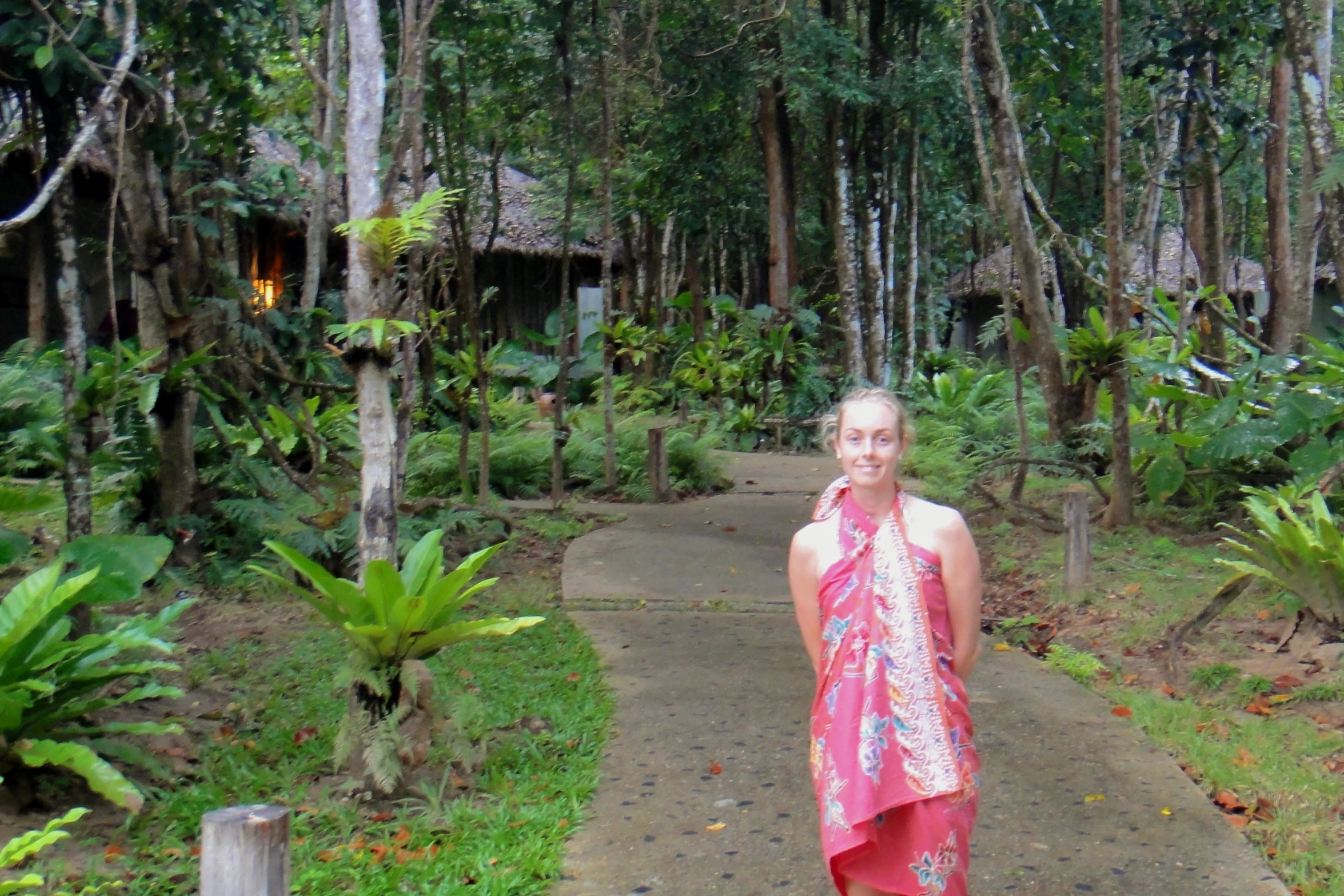 a person wearing a red dress is standing on a walkway