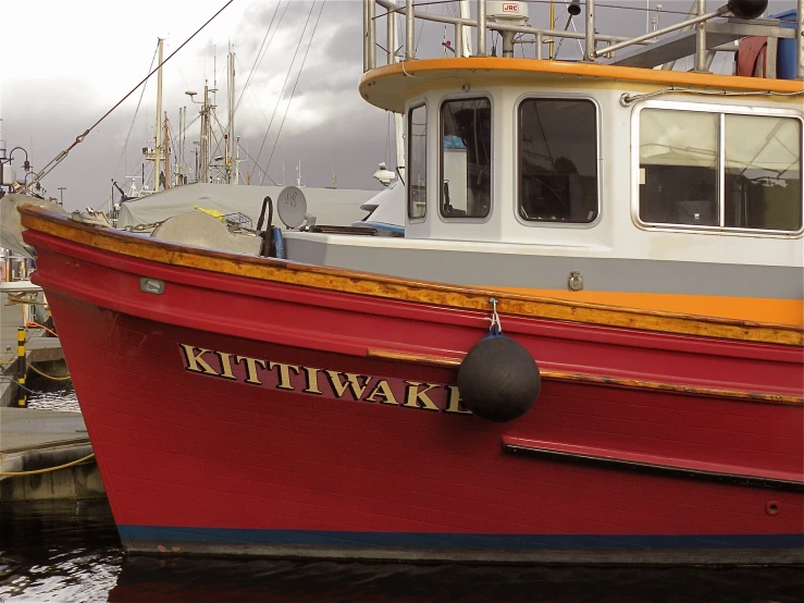 a boat docked at the dock, next to other boats