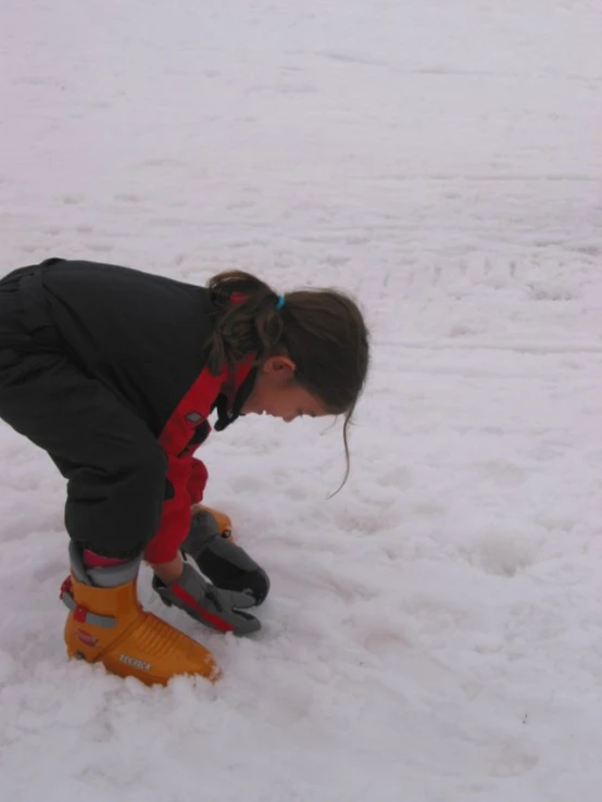 a young woman putting on a pair of yellow skis