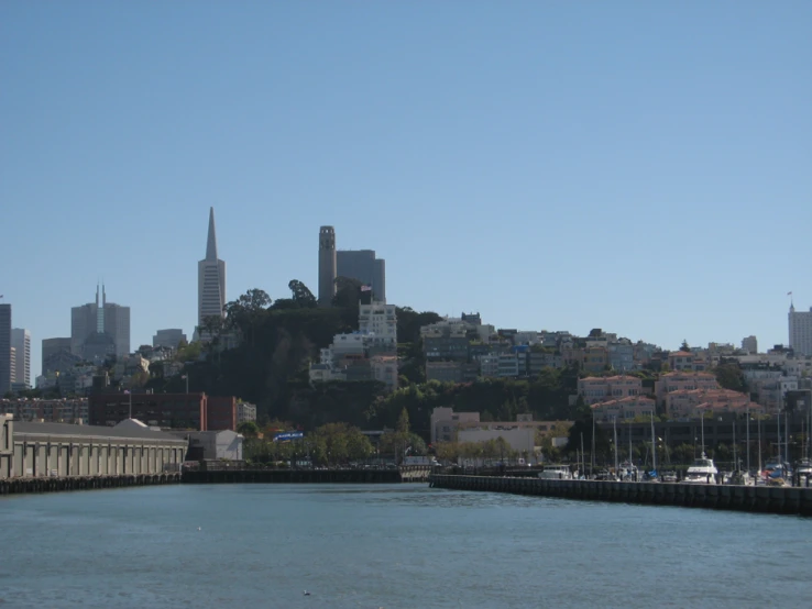 a body of water next to a city with a lake in the foreground