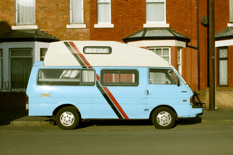 a van is parked in front of two red brick homes