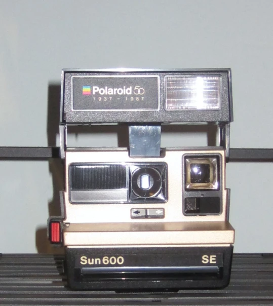 polaroid 500 is in front of a striped wall