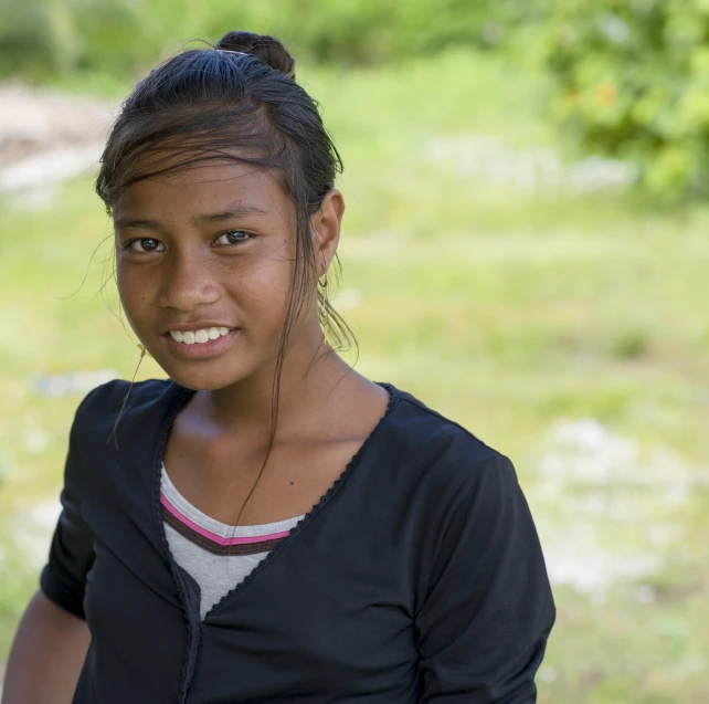 a young woman is smiling at the camera