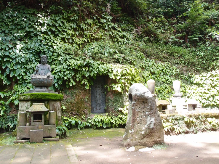 a group of statues outside a stone building