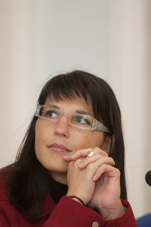 a woman sitting down and looking at the camera