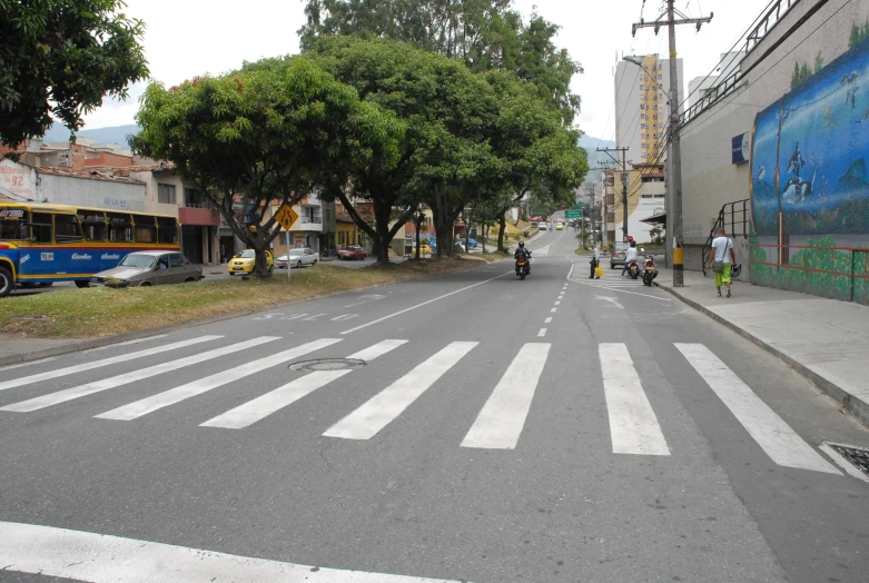 a street scene with a bus stopped at a traffic light