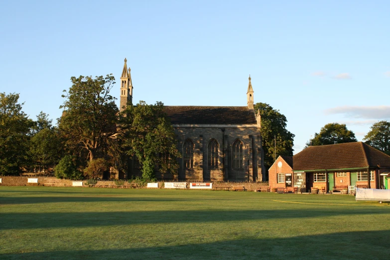 an old building with a clock tower next to a park