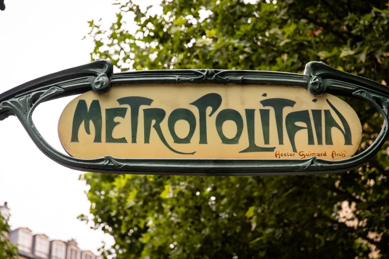 a street sign with the word metropolitan in an artistic font