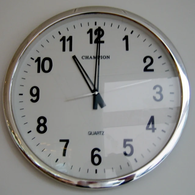 a clock with numerals and times on it