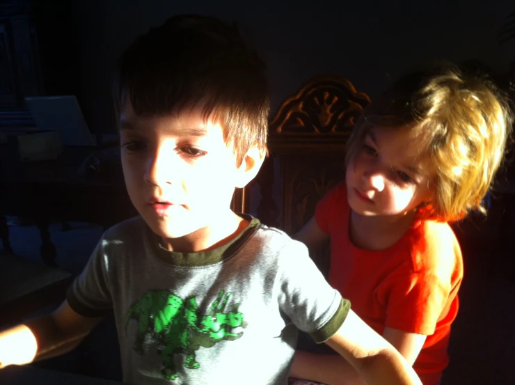 two young children are sitting together at the table