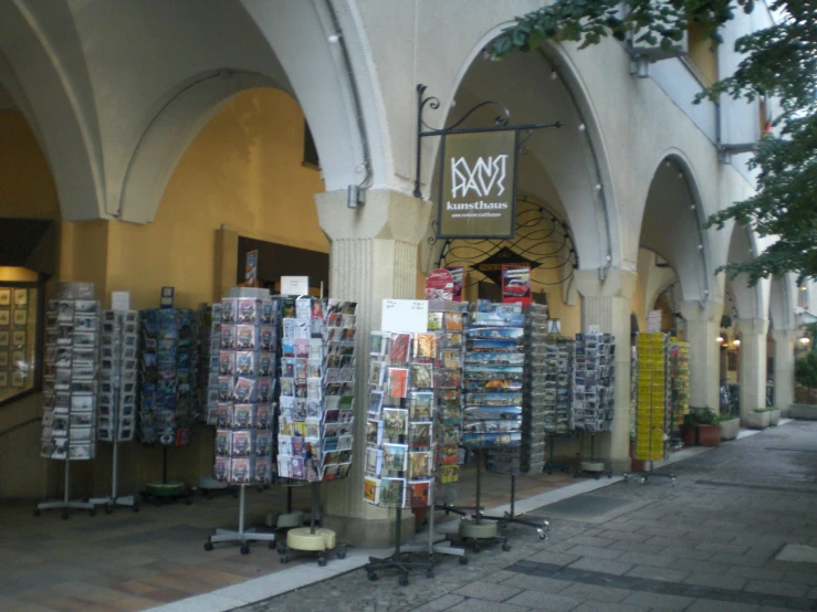 an outdoor market with magazine covers and newspaper racks