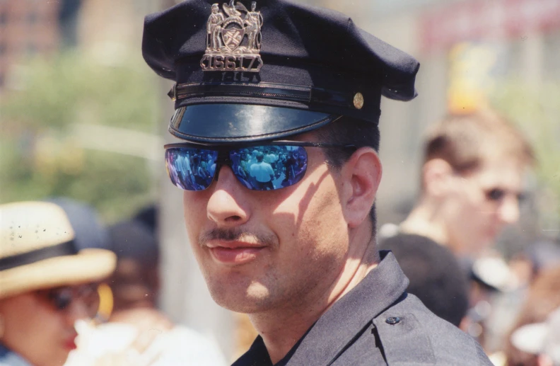 there is a man wearing police hat and glasses