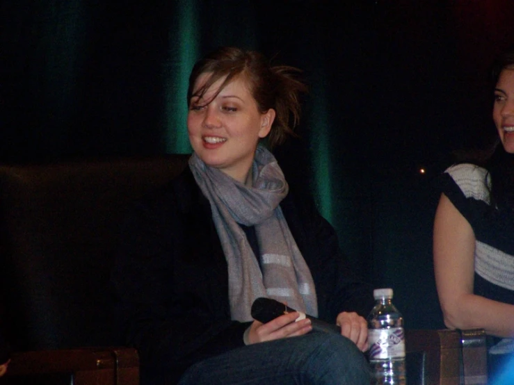 two woman sitting next to each other in a room