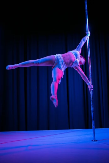 a women who is performing on a pole