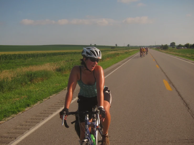 there is a woman riding her bike in the street