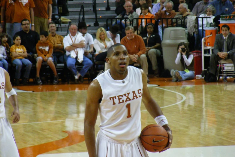 a basketball player has his hands in the air while standing