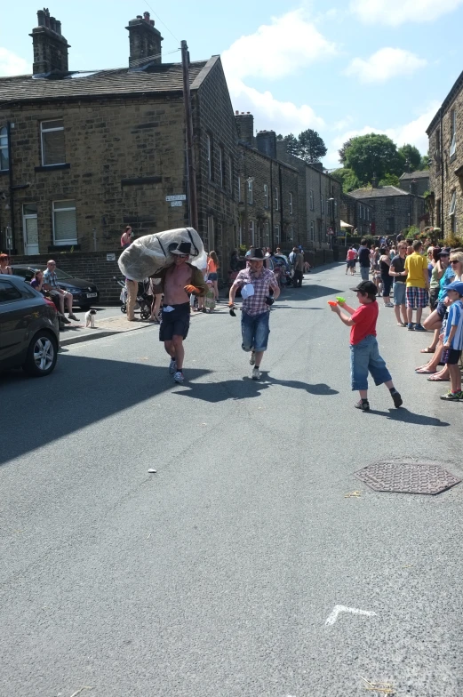 a large crowd of people walk down the street