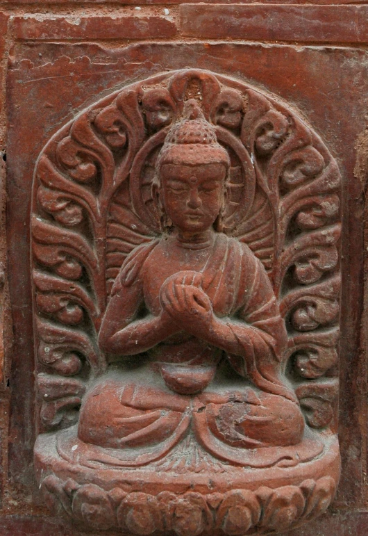 a statue of buddha holding an object