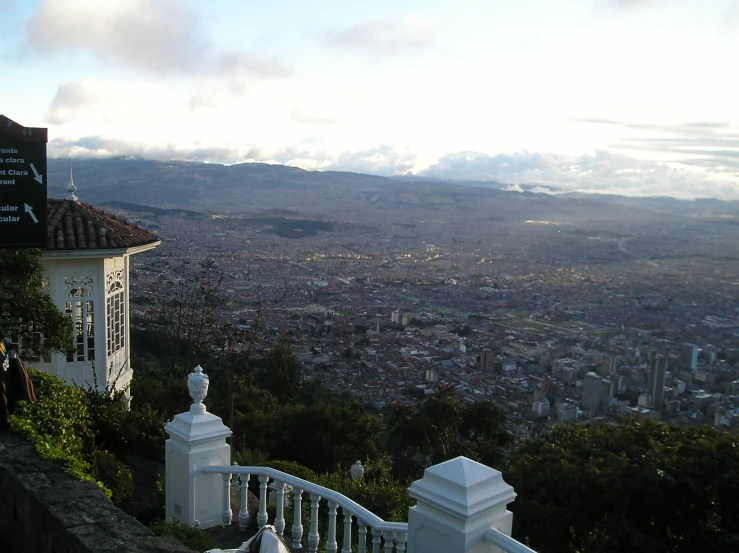 an overlook on a hill with views of some city