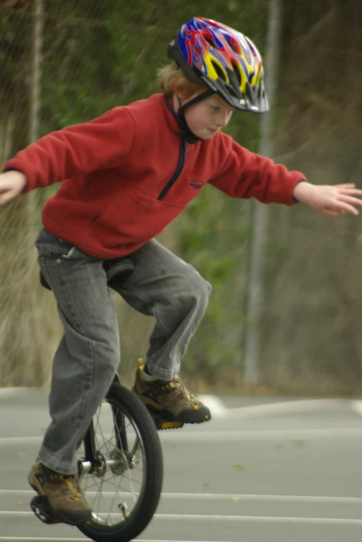 a  is skate boarding while wearing a helmet