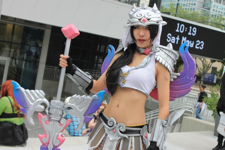 a woman in cosplay posing with an odd costume