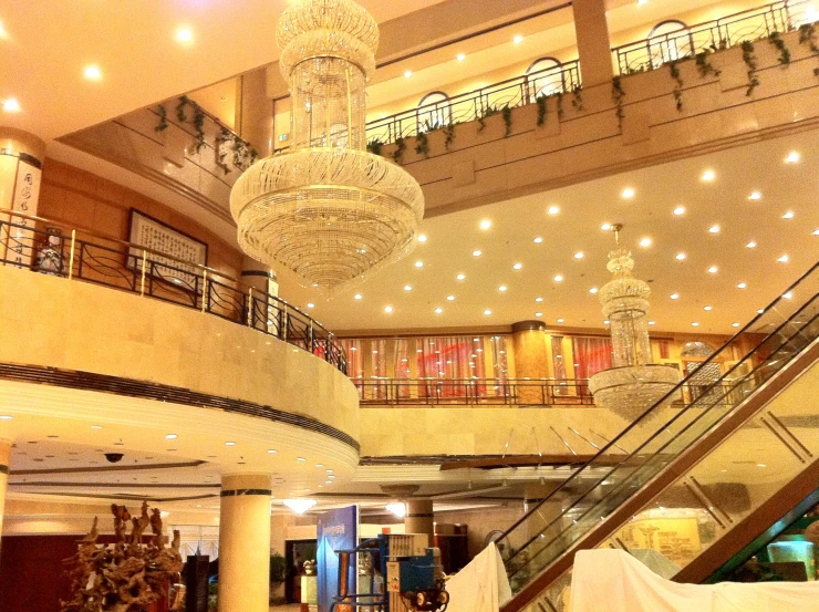 an open shopping mall with a chandelier and stairs