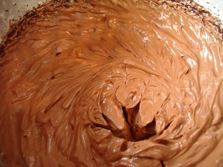 a big bowl with some chocolate frosting on it
