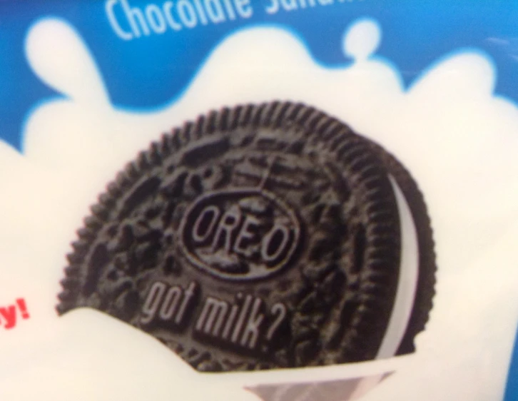 an oreo cookie has been placed in a box with milk