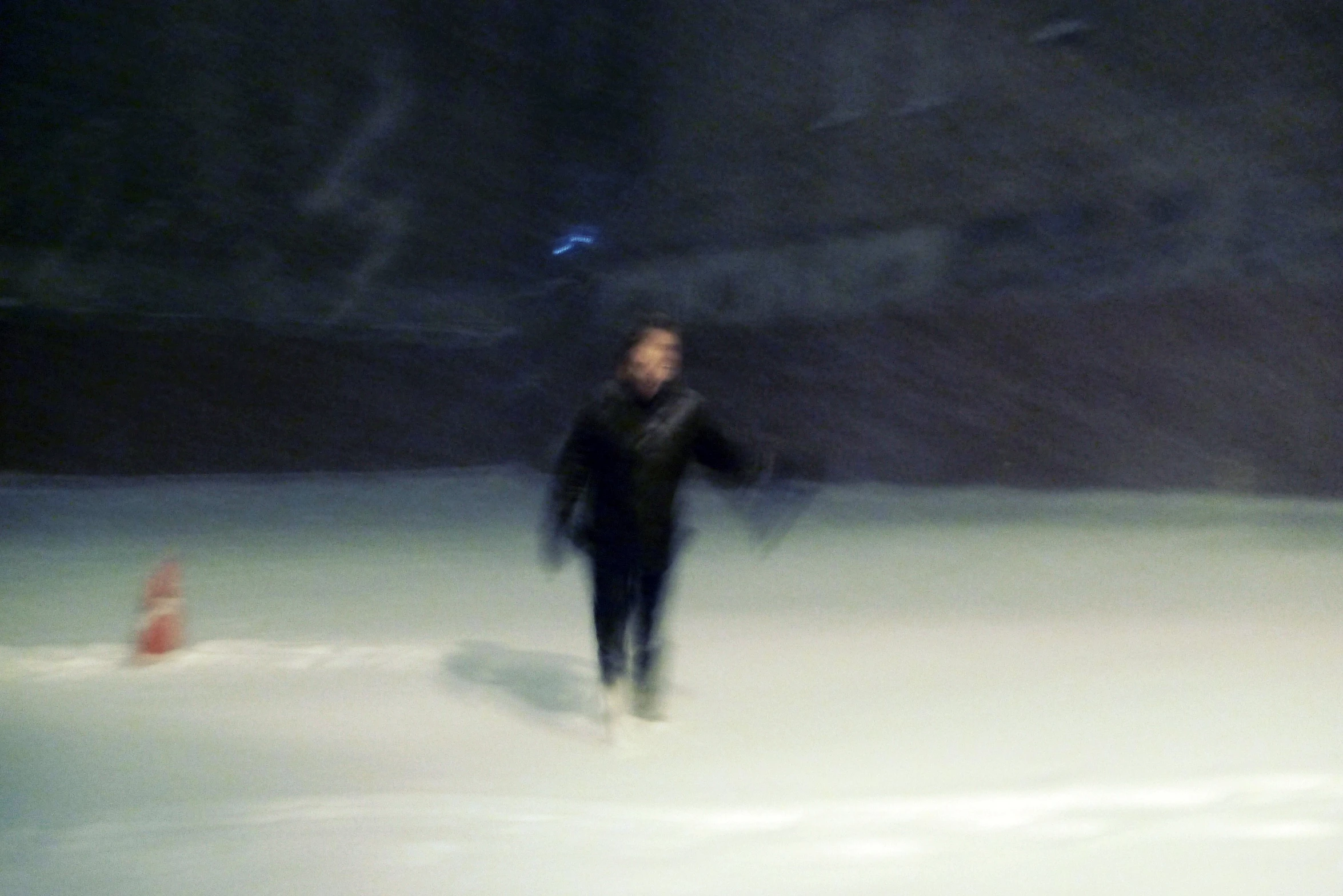 a man walking across a snow covered field