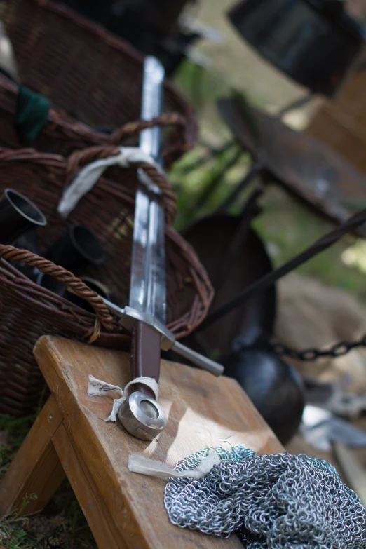 a wooden table topped with a knife and other objects