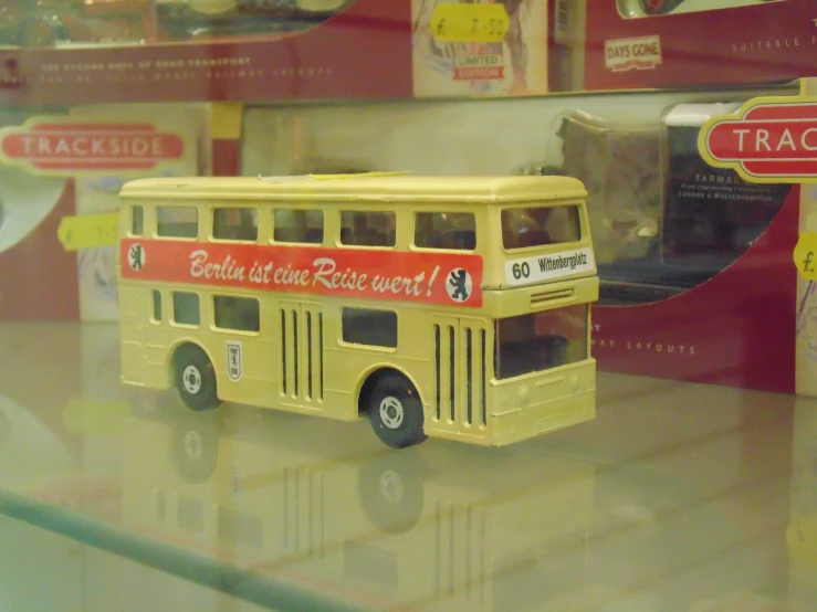 yellow toy bus is on display at a store