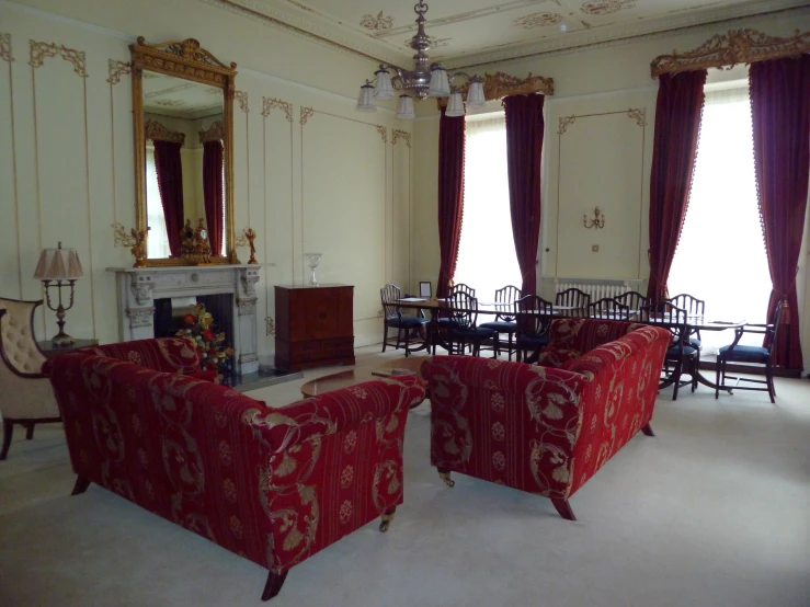 a big and fancy living room with a fire place