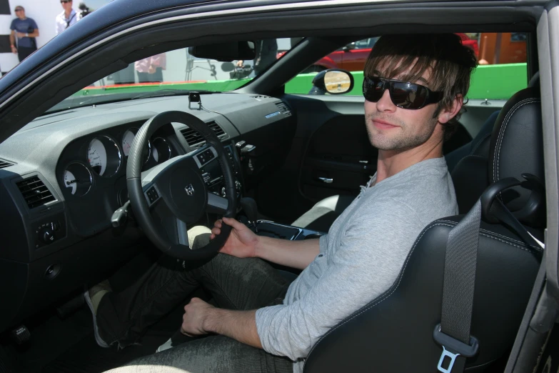 the man is driving his car and is smiling