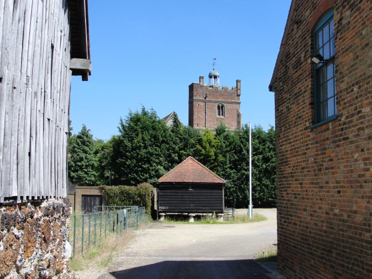 two brick buildings next to one another with trees in the background