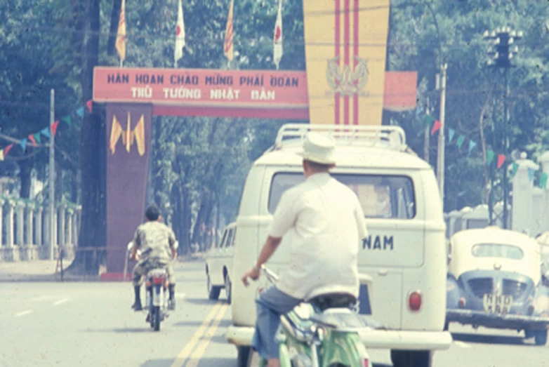 a man riding his bike past two motorcycles