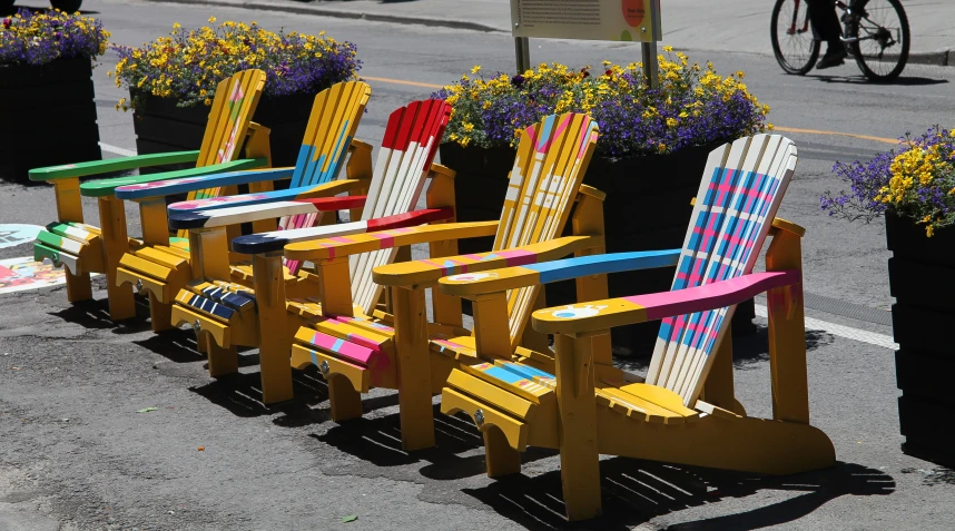 four lawn chairs are arranged on the pavement