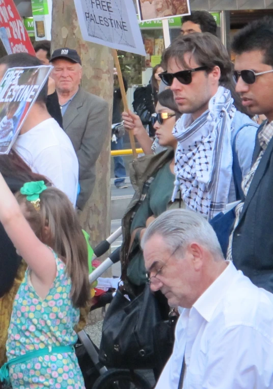 a crowd of people are protesting in front of a building