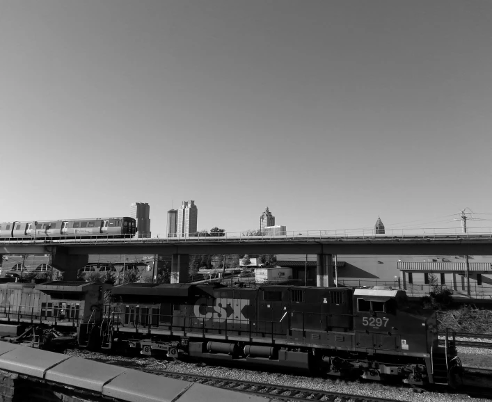 a train is passing in front of a large building