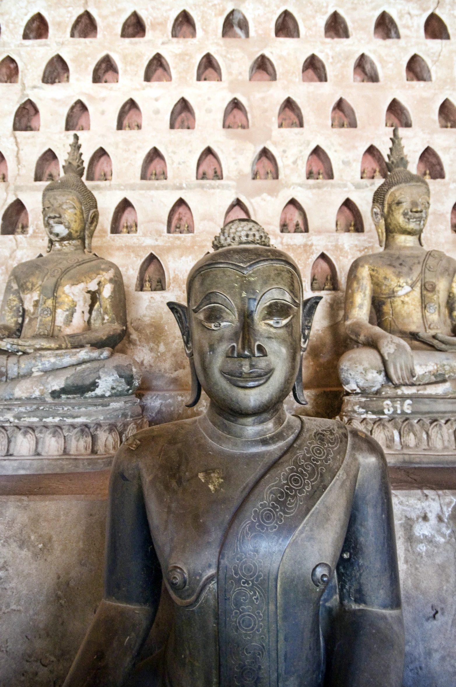 some statues on the ground with a building in the background