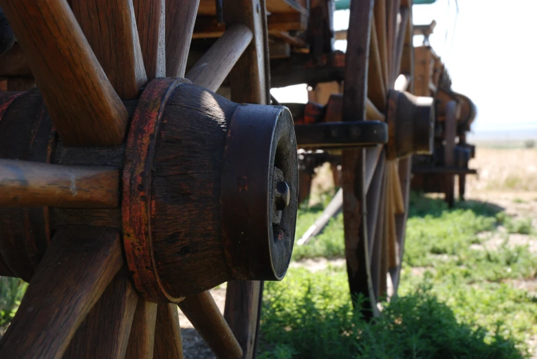 a bunch of wooden gears that are outside