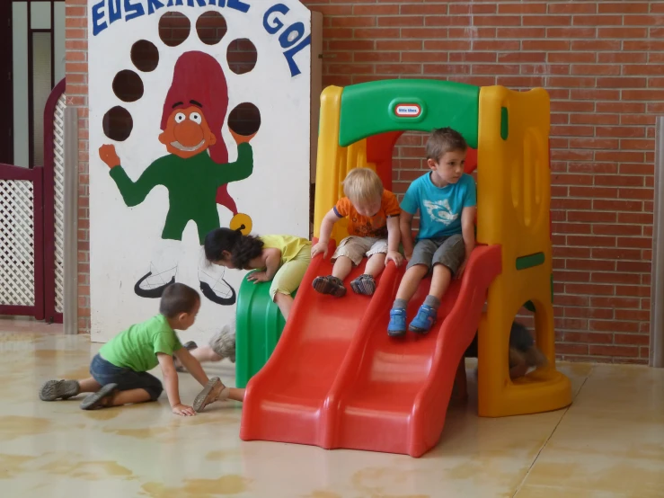 children playing with a children's slide and sign