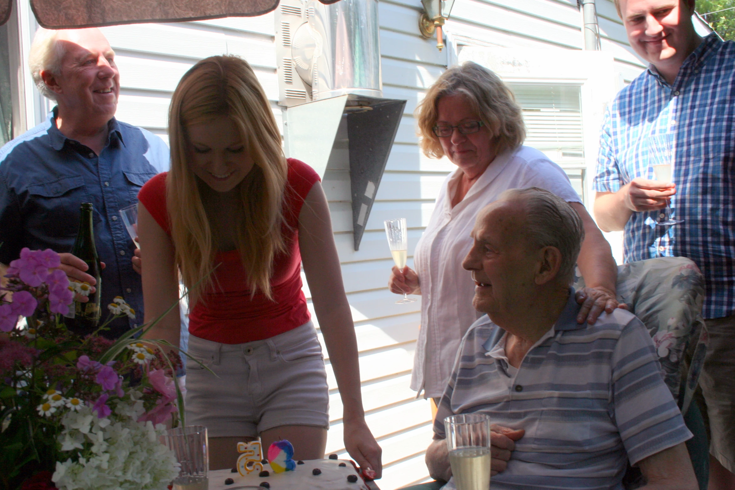 a group of people with cake on the table