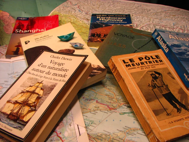 a pile of books on a map with brochures