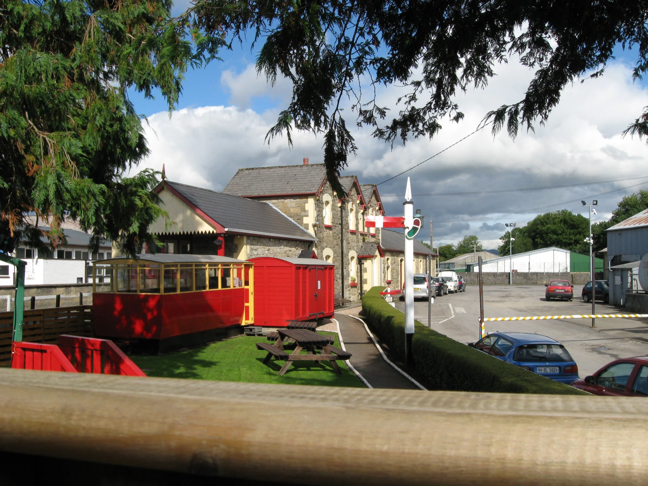 a small train car sitting outside of a building