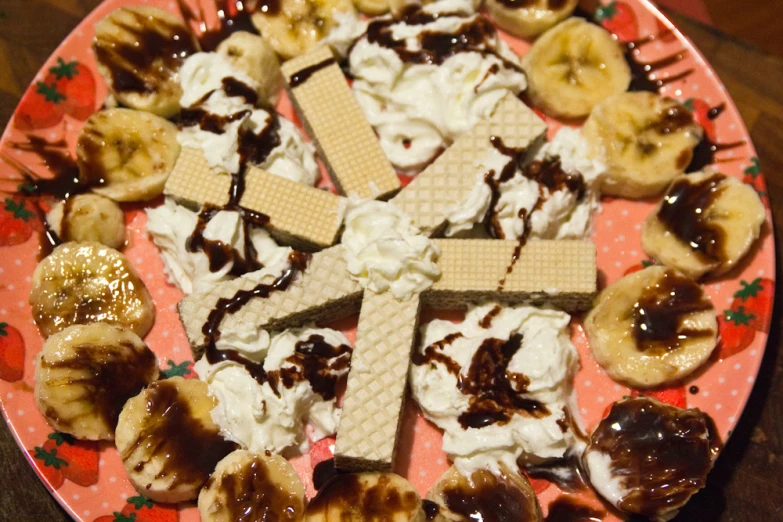 a pink plate topped with food next to sliced bananas