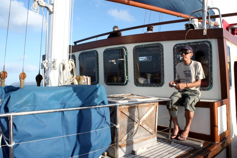 a man sitting on the front deck of a boat