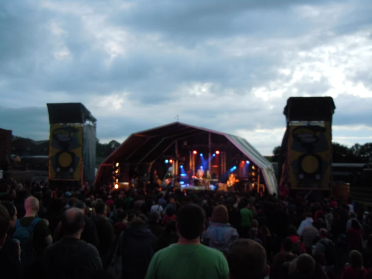 several people are looking at the concert on stage