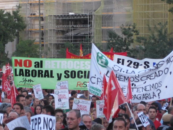 a group of people are holding signs protesting on their backs