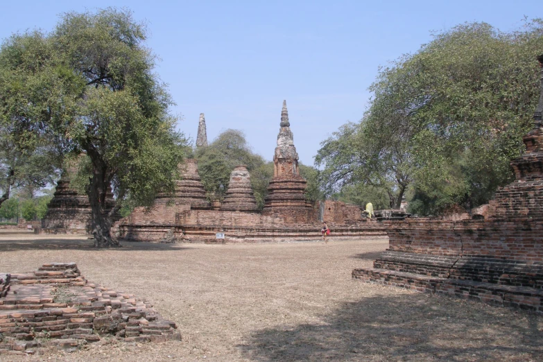 several large ruins are seen in this large outdoor courtyard