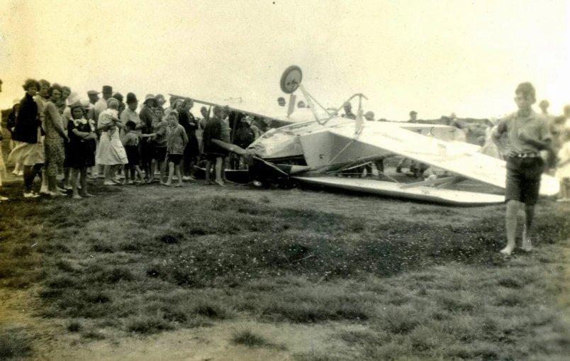 people standing outside of a flying device that is upside down